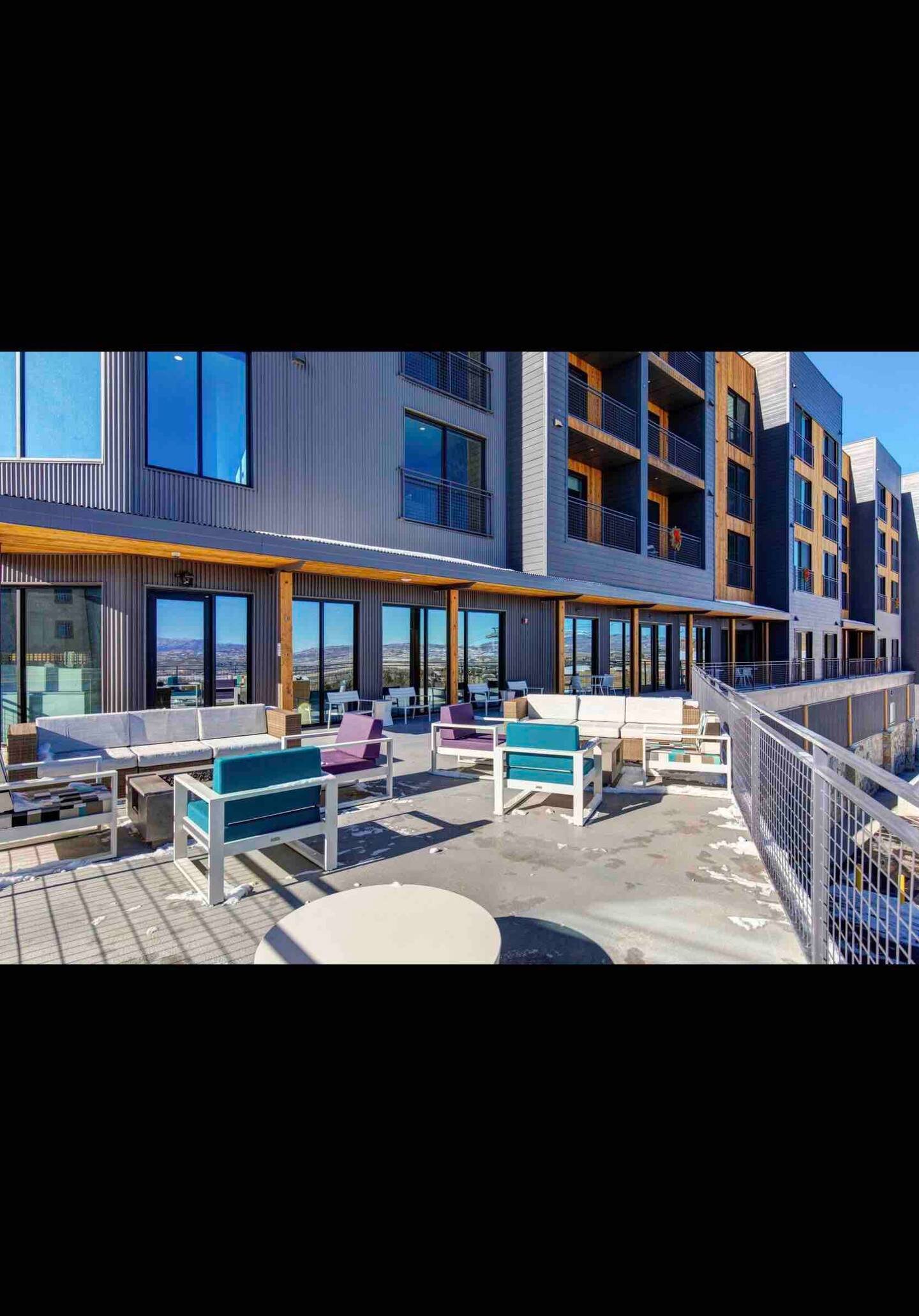 Building exterior terrace with modern seating and mountain views