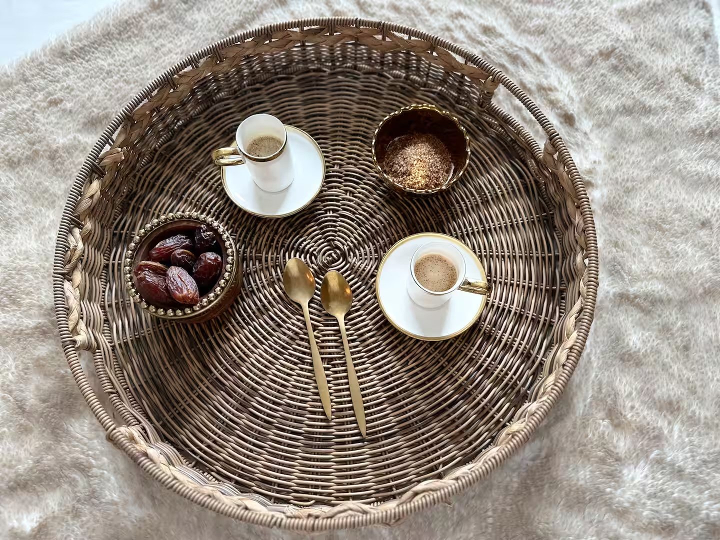 Turkish coffee and dates on wicker tray, fur throw