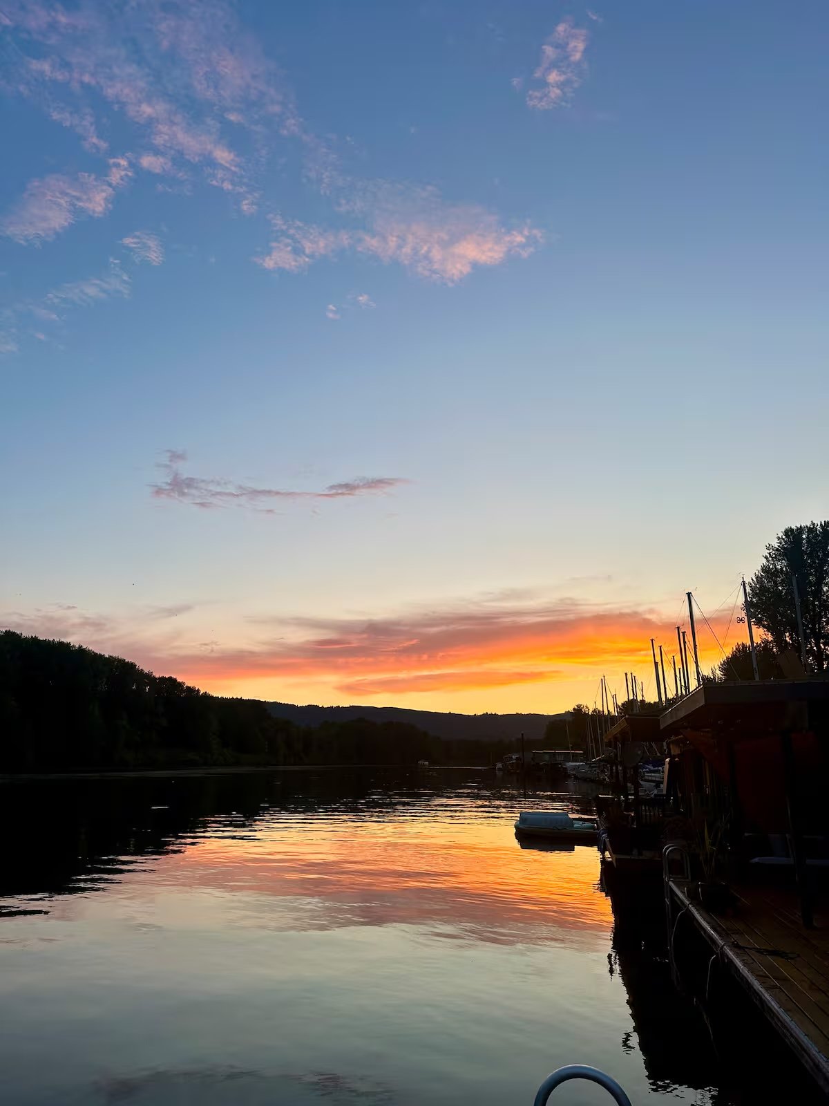Moorage sunset — pink and orange sky reflected on still water